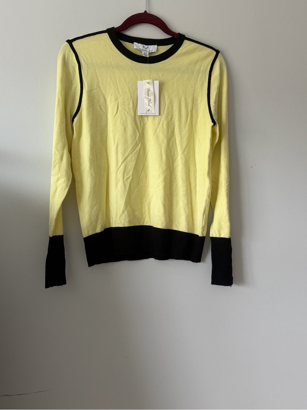 Magaschoni knit top features contrasting black trim at the neck